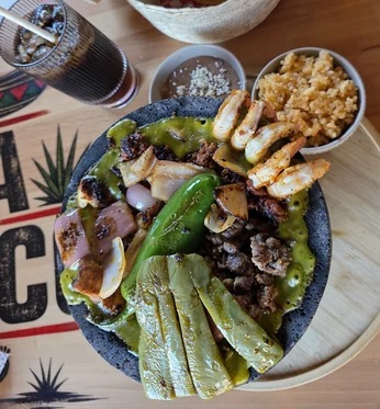 Molcajete Mixto with grilled steak, shrimp, nopales and salsa verde at MEXIKAN in Heritage Valley, Edmonton