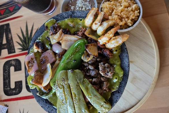 Molcajete Mixto with grilled steak, shrimp, nopales and salsa verde at MEXIKAN in Heritage Valley, Edmonton
