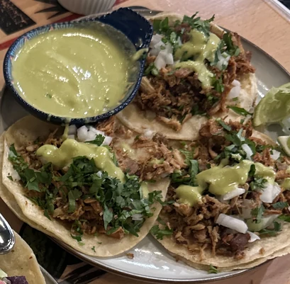 Carnitas tacos with cilantro, onion and avocado salsa at MEXIKAN in Heritage Valley, Edmonton