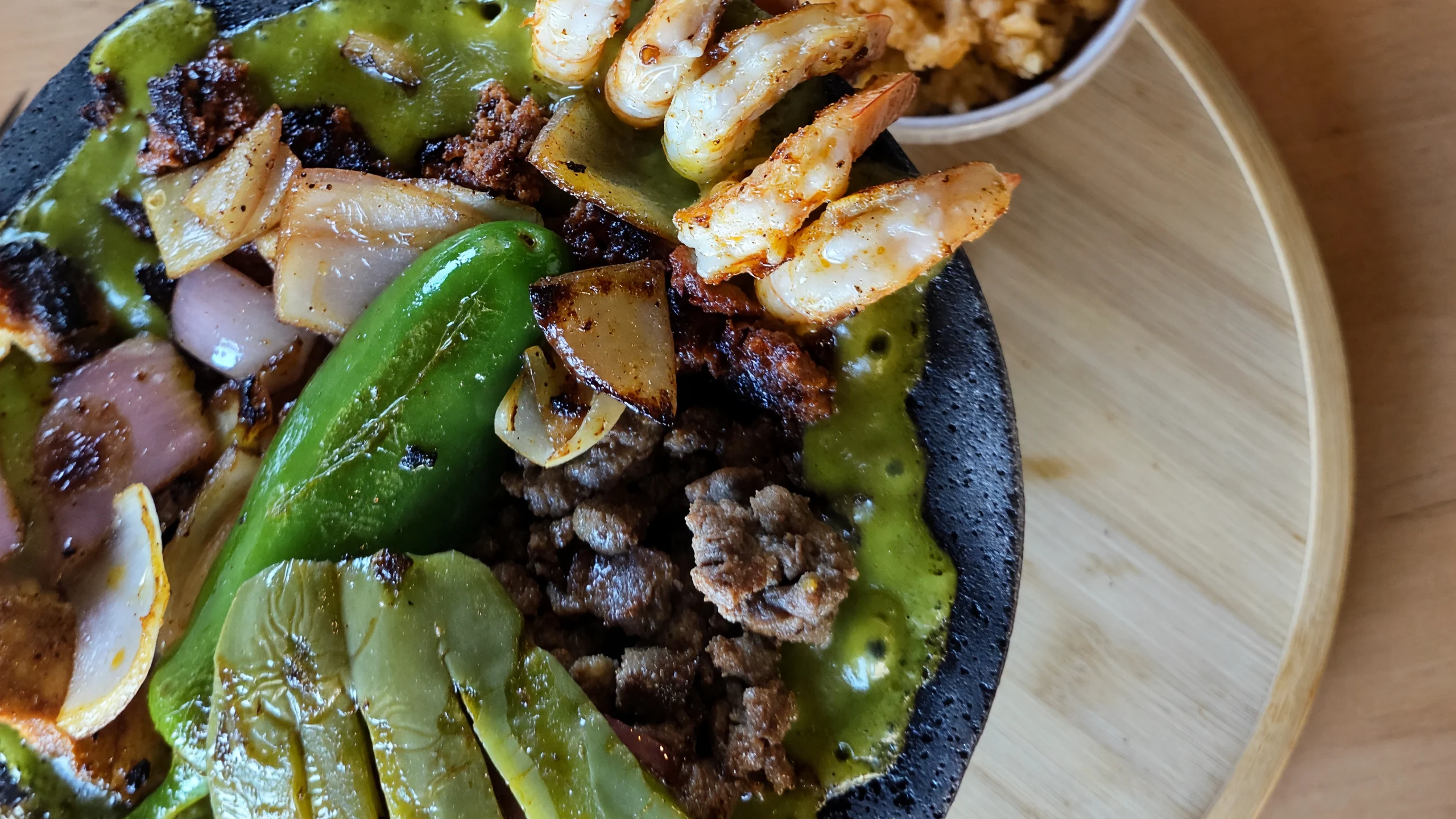 Molcajete Mixto with grilled steak, shrimp, nopales and salsa verde at MEXIKAN in Heritage Valley, Edmonton