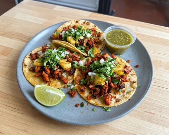 Al pastor tacos with pineapple, onion and cilantro