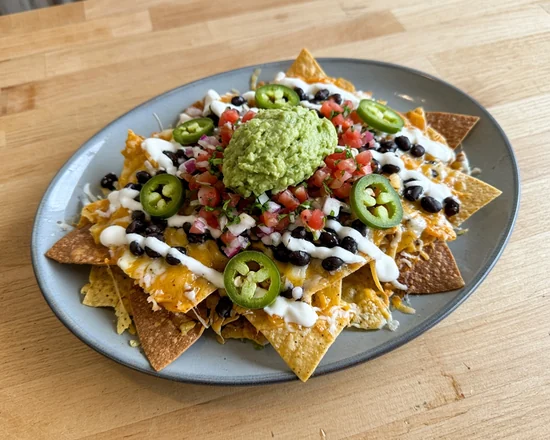 Loaded nachos with black beans, pico de gallo, jalapeños, crema and guacamole