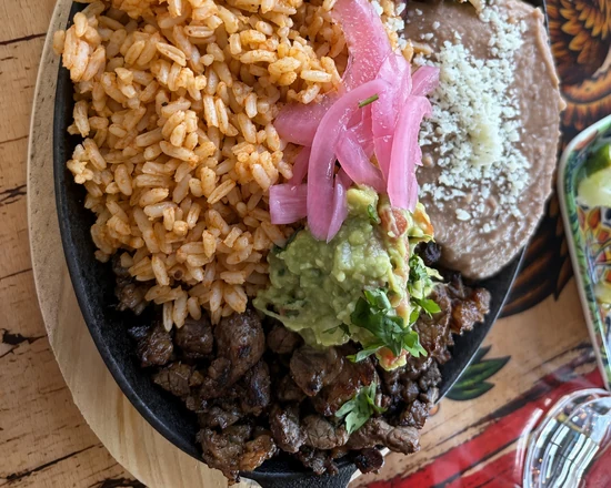 Carne asada platter with Mexican rice, house beans, guacamole and pickled onion at MEXIKAN in Heritage Valley, Edmonton
